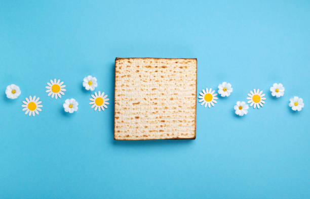 istock Passover Greeting Card with Matzah, Nuts and Spring Flowers on Blue Background. 1469464674
