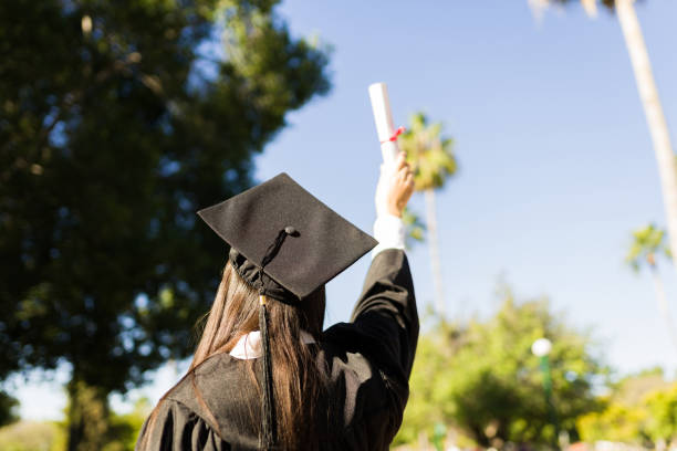 istock University graduate receiving her college diploma 1469465109