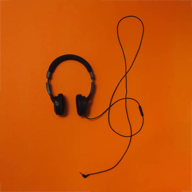 istock Black headphones on orange background. Flat lay image. Minimal concept. 1469467765