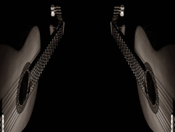 Classical acoustic guitar. On an isolated black background. With mirror reflection. Space for copy text. Close-up studio photography with fine details.