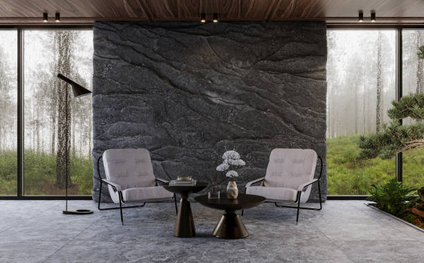 Modern living room interior with panoramic windows and natural rock wall