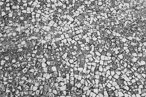 Black and white photo. Texture of paving slabs. The background of the stone