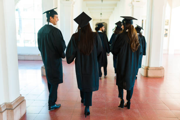 istock Rear view of graduates walking on university campus 1469470861