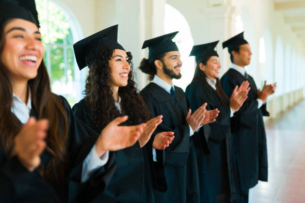 istock Happy women and man clapping celebrating graduating college 1469471020