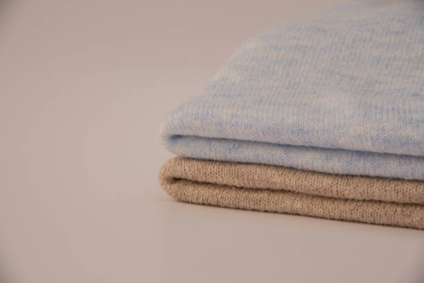 istock Stack of folded knitted sweaters close-up isolated on white background 1469474302