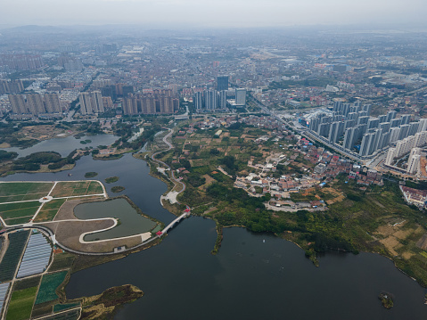 Aerial view of buildings and high-rise buildings in waterside town