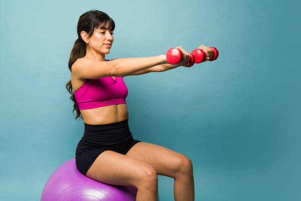 istock Gorgeous athletic young woman exercising with weights 1469476913