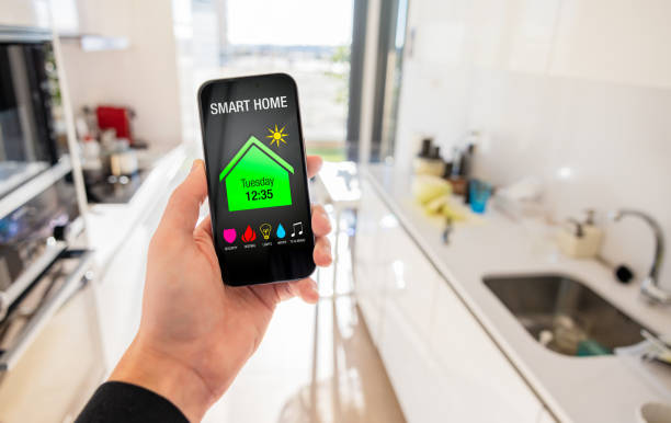 istock Person using smart home app on mobile phone 1469477389