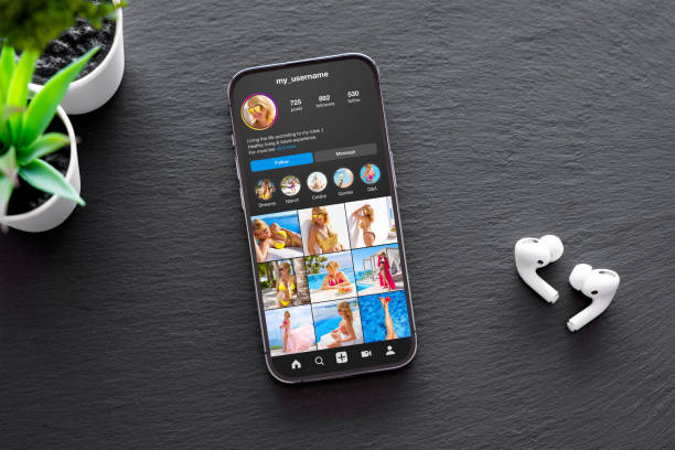 istock Sample social media user profile on mobile phone on dark background 1469477407