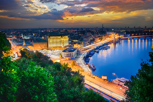 Picturesque evening landscape of the Postal Square, the river station and the Dnieper River in the capital of Ukraine, the city of Kyiv. Skyline of Podil and Obolon at night in Kiev.