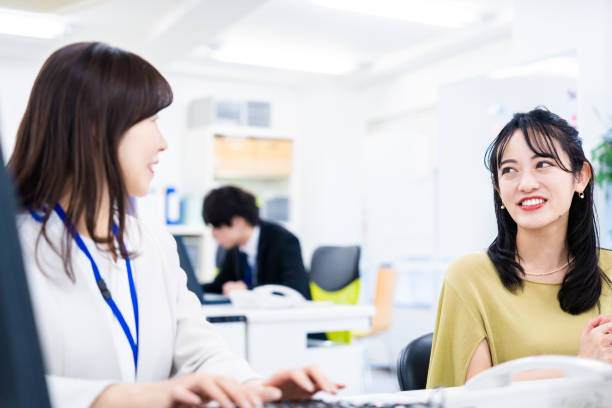 istock Woman working at her desk while having a nice talk 1469481598