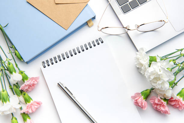 istock Modern white office desk table with laptop, notebook and other supplies. 1469482612