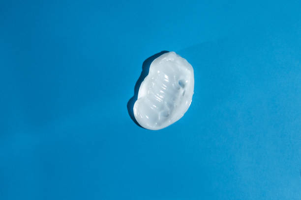 istock cream texture on a blue background, moisturizing hyaluronic lotion for face and body 1469483025