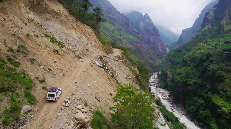 AERIAL SUV drives on a dangerous dirt road in Nepal. Kali Gandaki Gorge