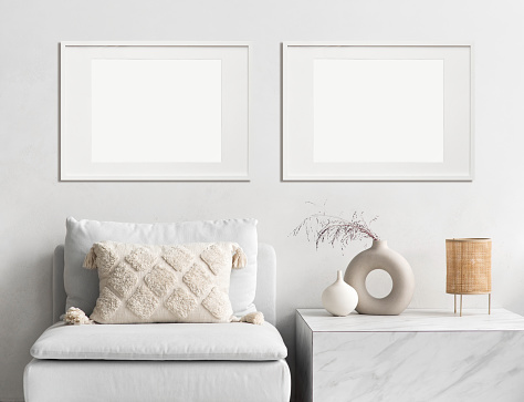 View of modern interior design. Minimalism boho style. Blank white empty frame mock up for painting or poster.