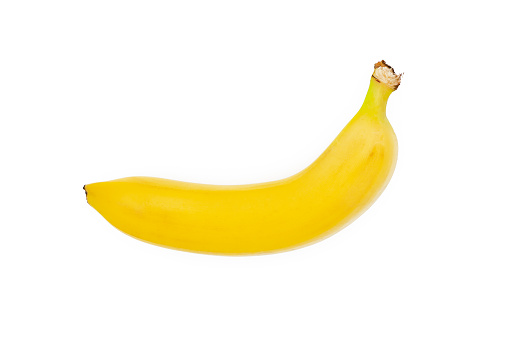 Single banana against white background. Most popular worldwide fruit.