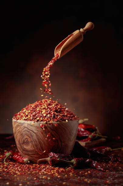 istock Chilli flakes are poured into a wooden dish. 1469484850