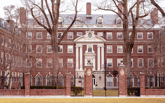 Cambridge, MA, USA - February 19, 2023: The historic architecture of Cambridge in MA, USA showcasing one of the brick buildings of Harvard University at Memorial Drive road.