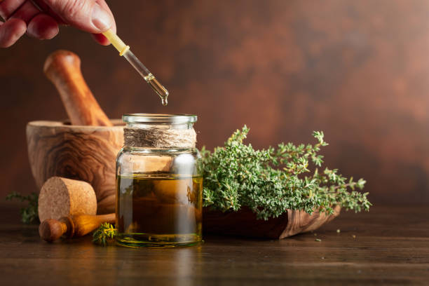 istock Bottle of thyme essential oil with fresh thyme. 1469484940