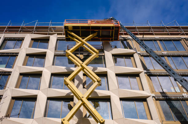 istock mounting a modern building facade from an extended scissor lift 1469487197