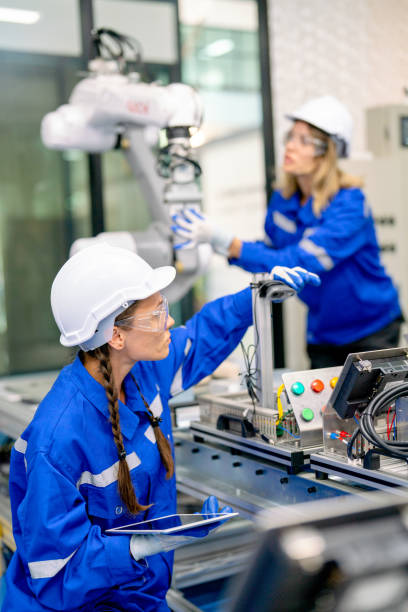 istock Two professional engineers or technician worker women help to check and maintenance robotic arm machine in factory workplace with quality control system. 1469487320
