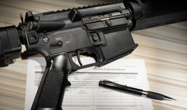 istock Assault rifle with public domain FBI Background check form 1469487398