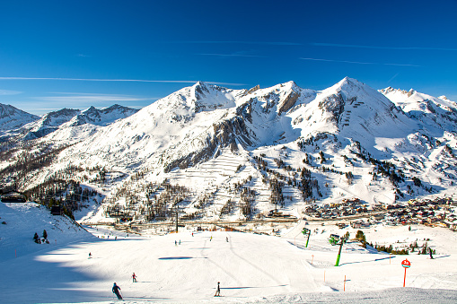 Obertauern, Salzburg area, Austria - Ski resort, hut, skiers and slope in Austrian Alps