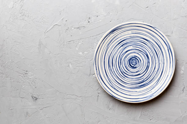 istock Top view of empty colorful plate on cement background. Empty space for your design 1469493587