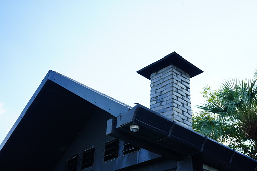 A red brick masonry chimney on a residential home.