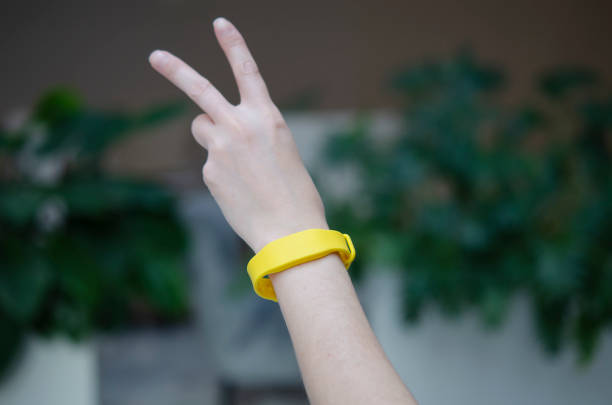 Yellow access bracelet with a chip. Contactless silicone key pass. stock photo