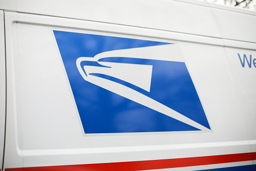 providence, rhode island, USA - February 25, 2023: united states postal service mail box and truck for mail delivery