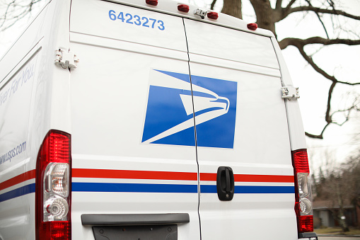 providence, rhode island, USA - February 25, 2023: united states postal service mail box and truck for mail delivery