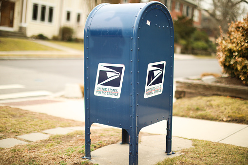 providence, rhode island, USA - February 25, 2023: united states postal service mail box and truck for mail delivery