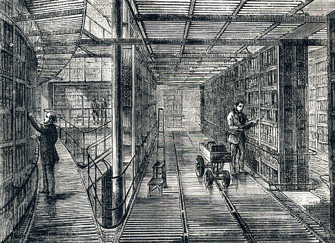An illustration of bookcases in the reading room of the British Museum