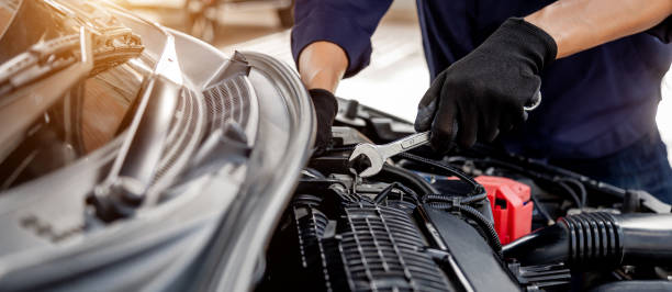 istock Car care maintenance and servicing, Close-up hand technician auto mechanic using the wrench to repairing change spare part car engine problem and insurance service support. 1469502783