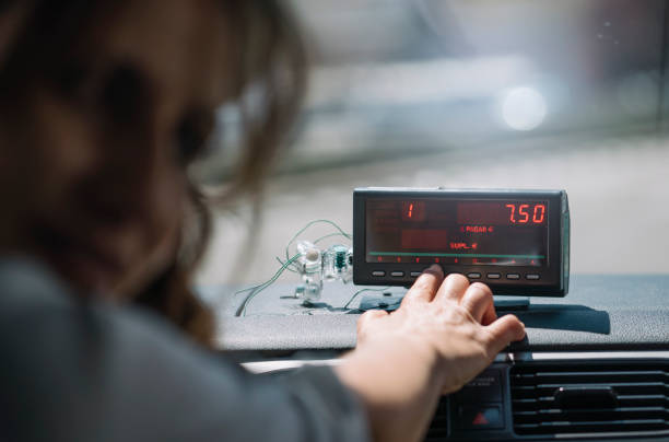 istock Woman's hand driving taxi machine. 1469503962