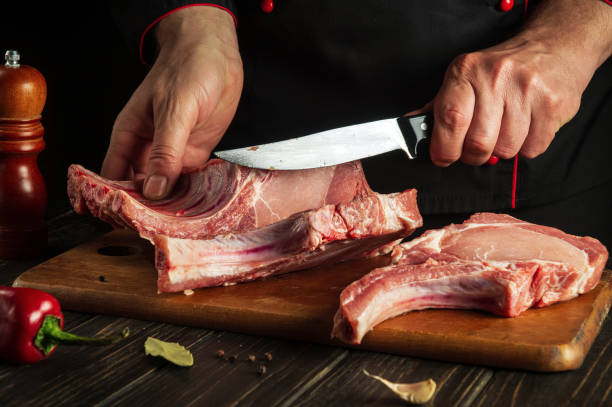 istock A professional chef cuts raw ribs on a cutting board before baking. Asian cuisine. Cooking delicious food in the kitchen 1469504389