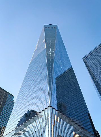 One world trade center in New York, USA. Low angle view of freedom tower against the clear blue sky in New York City.