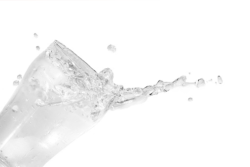 Ice cubes falling in a glass of cold fresh water