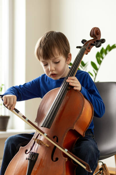 istock White 5 year old boy learning to play the cello 1469507748