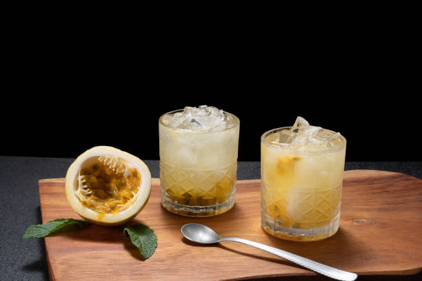 istock passion fruit mojito, passion fruit cocktail, passion frutis coollins, on a black background 1469507751