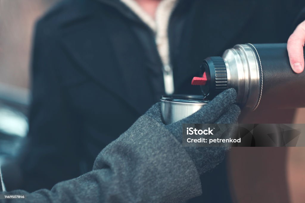 Anonymous Men Using Thermos Stock Photo - Download Image Now