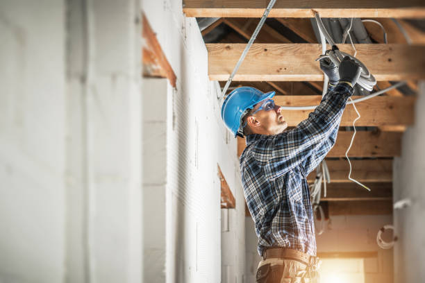 Electrician Installing Wiring System in the Ceiling Professional Caucasian Electrician Working on Electrical Wiring System Installation in New Residential House Ceiling. electrician stock pictures, royalty-free photos & images