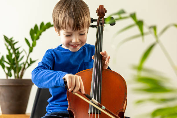 istock White 5 year old boy learning to play the cello 1469511042