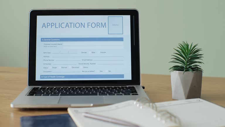 Laptop computer with an Application Form on its display.