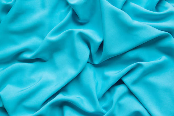 background from turquoise fabric. the texture of the fabric. - article textile material new imagens e fotografias de stock