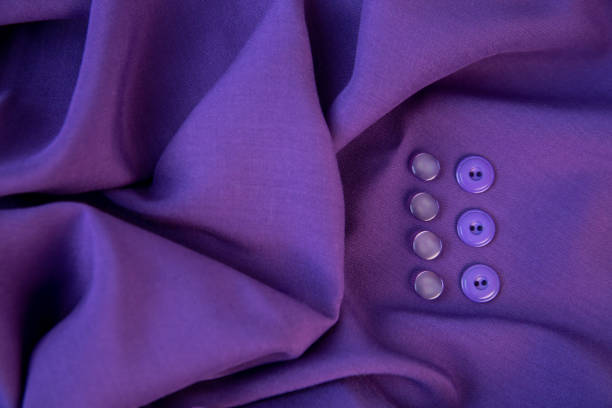 background of purple fabric and buttons lying on it. the texture of the fabric. - article textile material new imagens e fotografias de stock
