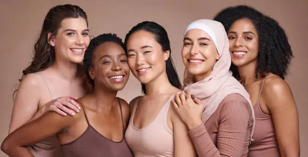 Photo of Diversity, women and beauty with skincare and portrait, smile and happy models, different and empowerment with motivation against studio background. Inclusion, equal and gender with culture and skin.