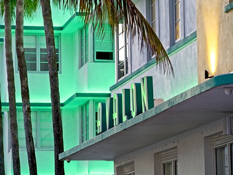 Miami Beach, FL - USA, February 1, 2023. Hotel Avalon bright neon lighting on Ocean drive, Miami beach Florida. One of many art deco hotels with colorful lighting.
