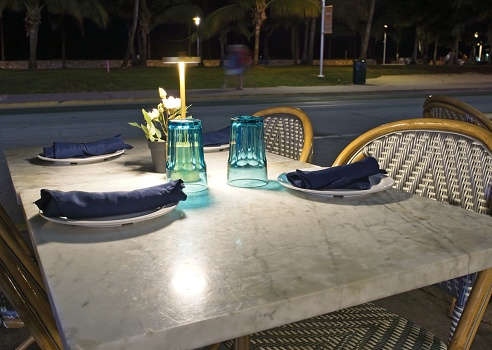 Sidewalk caffe table setting at night along Ocean Drive Miami Beach Florida